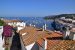 Panorama sur les façades, les toits et le port de Cadaqués avec ses nombreux bateaux.
